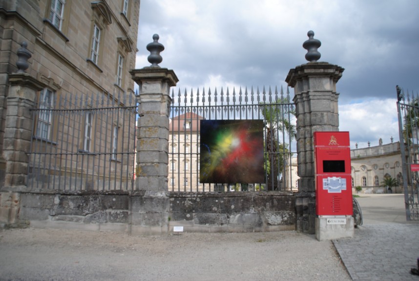 Explosive modern art hanging at the gate of a baroque castle